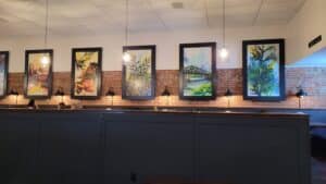 Restaurant Booth Seating with Custom Paintings of Iowa Scenes behind them